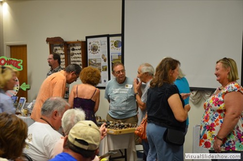 Bill Blazek (center) discussing hand-sanding sea-beans with Ike and Elaine Alvo